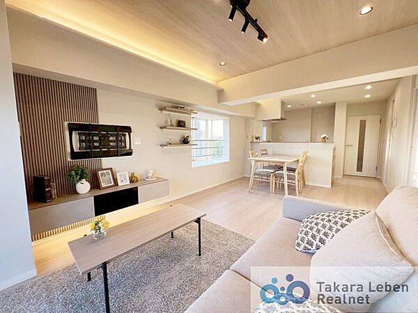 約14.8帖のLDK。ダウンライトと間接照明が暖かく照らす、居心地の良いリビングです。