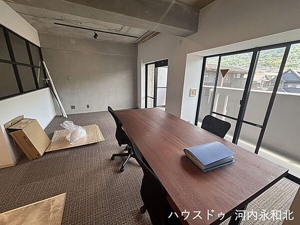 大きな窓から遠くの緑を望む、開放感のある設計。