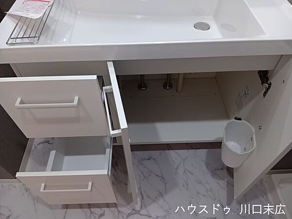 洗面台下部には、日用品のストックなどを整理できる引き出しと開き扉の収納を配置。使い勝手を考慮した設計で美しい空間を維持します。