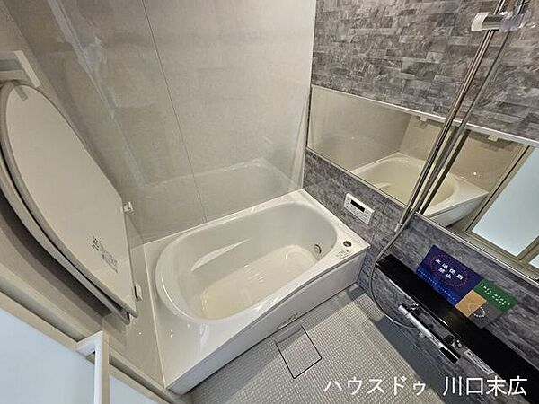 清潔感溢れるスタイリッシュな浴室。横長鏡や手すりを備え、安心感と快適性を両立した一連の設備が魅力です。