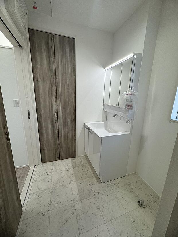 三面鏡付き洗面化粧台。収納力があり、朝の身支度もスムーズです。