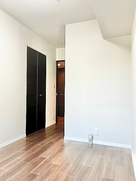 ダーク調フロアと黒の建具がホワイト壁紙に美しく映えるスタイリッシュな居室！便利なクローゼットやコンセント設備を備え、寝室や書斎、テレワーク部屋としても使い勝手の良い快適な一室です。