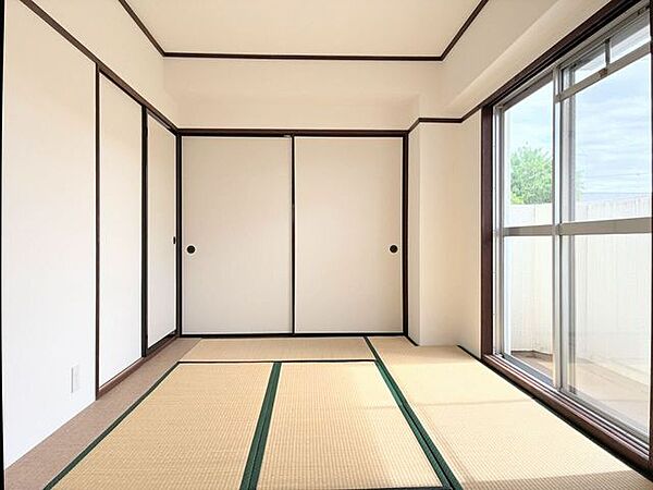 日差しが降り注ぐ大きな窓のある和室です
