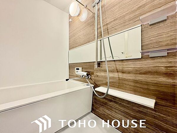木目調のアクセントパネルがリラックス空間を演出するバスルーム。一日の疲れをゆっくり癒やせます。
