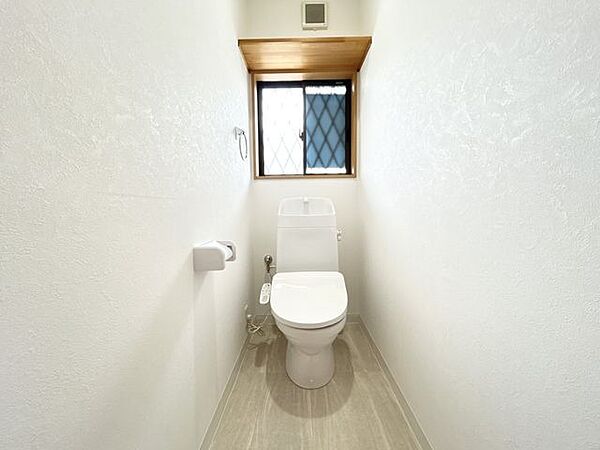 【1階トイレ】玄関横にトイレがございます。手洗い場が別にあったり、トイレ上には棚がついているので痒い所に手が届く設計になってますね。