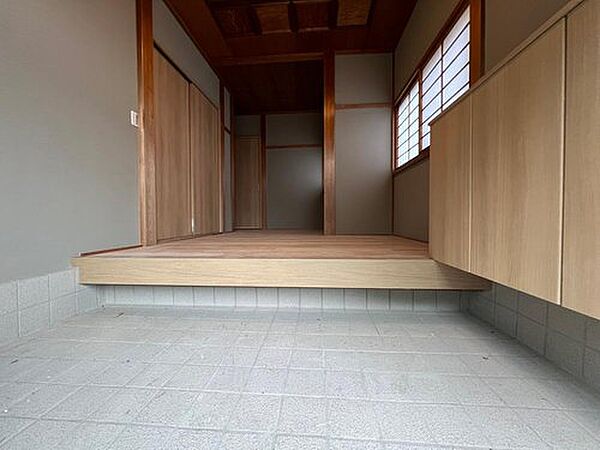 【リフォーム完成】クロス張替え、フロアタイル重ね張り、下駄箱新品交換、ハウスクリーニングで綺麗になりました。格天井の美しい木目を残して印象的な、趣のある玄関になりました。