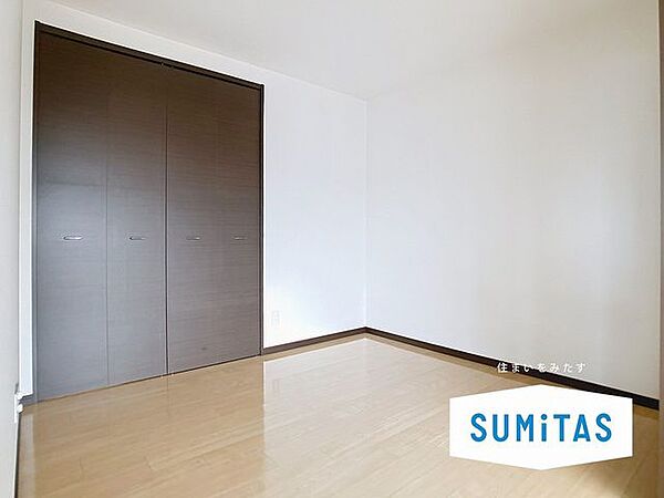落ち着いた深みのある色合いのフローリングと建具を採用した洋室