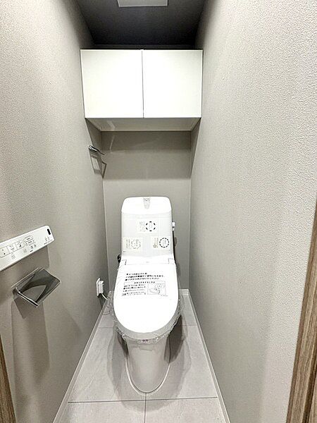 上部収納付きで空間を有効活用した清潔感あるシンプルなトイレ空間上部収納付きで空間を有効活用した清潔感あるシンプルなトイレ空間