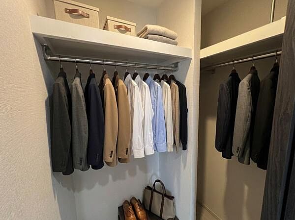 6帖の洋室にはWICを完備しています。ハンガーパイプの下部スペースにはゆとりがあるため、お好みのキャビネットや衣装ケースを並べて自由にレイアウトを変更できます。（調度品はAI生成となります。）