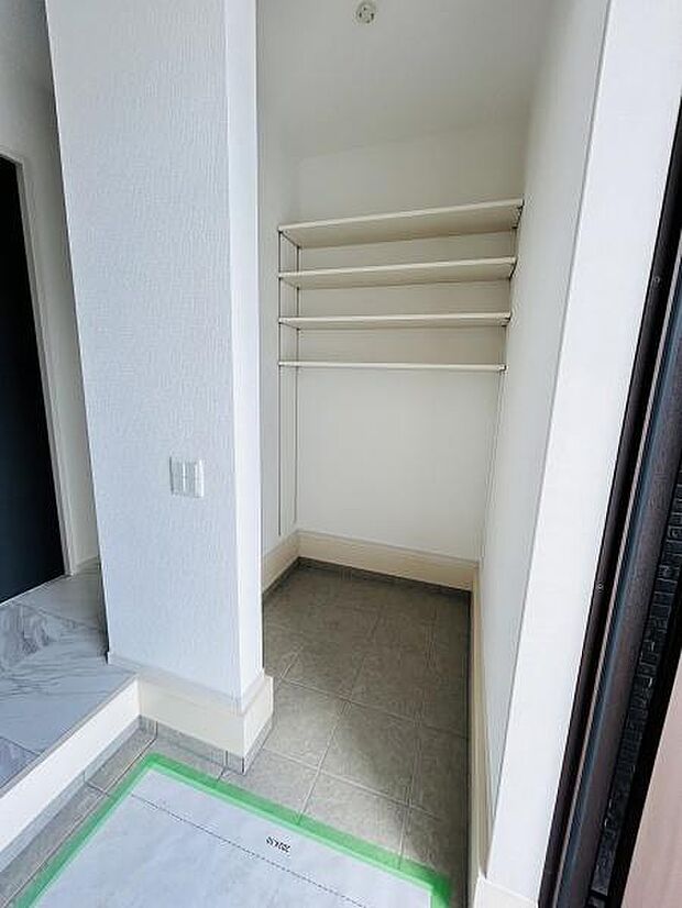 広々とした収納スペースが確保されています。可動式の棚が設置されており用途に応じて高さを調整できます。玄関横にあるので使い勝手も良好です。整理整頓がしやすい設計となっています。