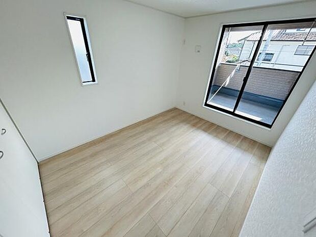 明るい日差しが差し込む清潔感のある子供部屋です。大きな窓が開放感を演出しています。シンプルな内装が特徴です。収納スペースも備えています。