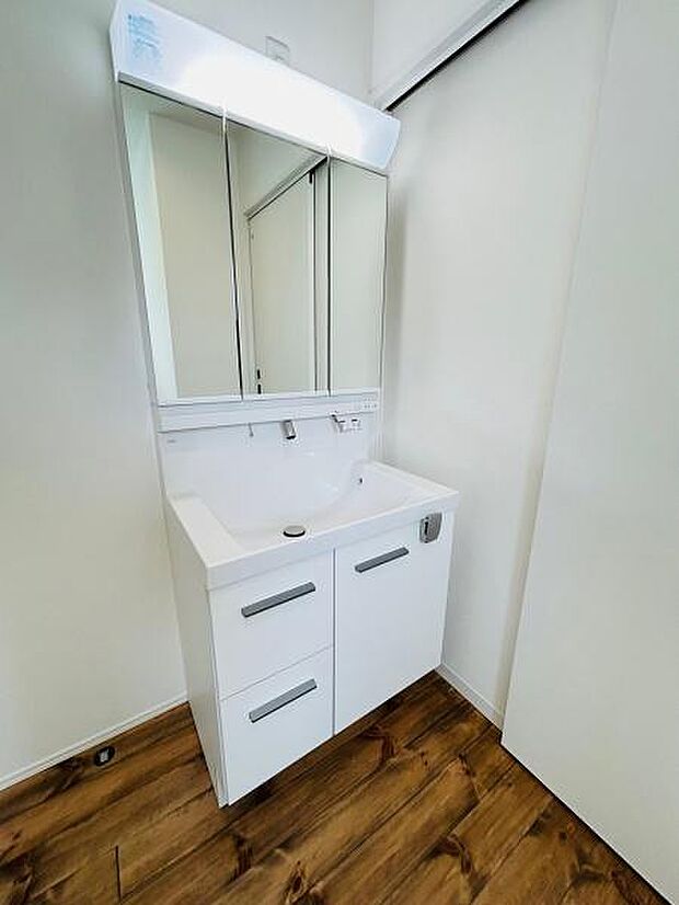 シンプルで清潔感のある洗面台が特徴です。収納スペースが充実しているためすっきりとした空間を保てます。鏡が大きく身支度も快適に行えます。床材とのバランスも良好な洗面所です。