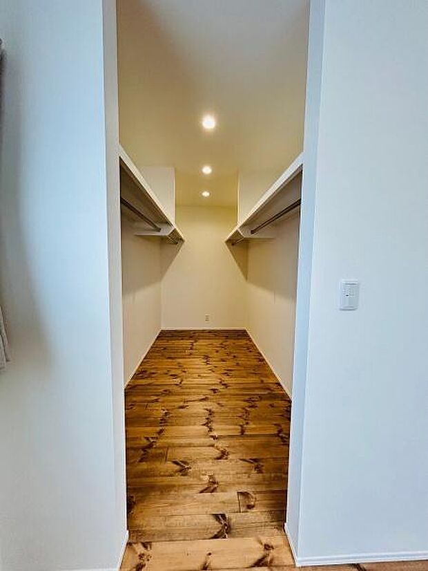 シンプルなデザインで幅広い用途に活用しやすい収納スペースです。壁面にはしっかりとした棚が設置されています。照明が複数配置されているため中が見やすい造りです。入口から奥行きも確保されています。