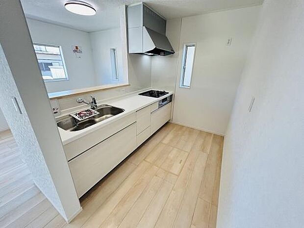 明るい室内に調和するシンプルなキッチンです。広々としたカウンターで使いやすさが際立ちます。大型シンクや窓からの光も魅力の一つです。収納スペースも充実しており整理整頓がしやすい設計です。