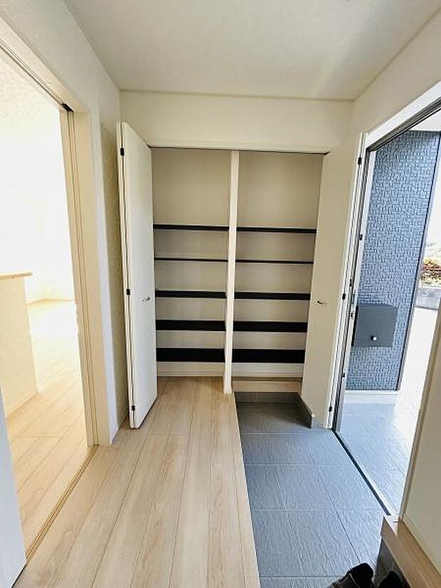 玄関は収納スペースが充実していて整理整頓がしやすい設計です。開放感のある空間で室内への動線もスムーズです。床の色使いが明るく清潔感が感じられる印象です。