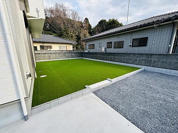 手入れがしやすい人工芝が敷かれた庭です。広々としたスペースがあり活用方法の幅が広がります。外構と庭の境界がすっきりと整えられています。遮るものの少ない開放的な環境です。