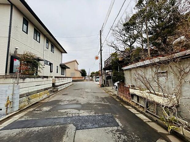 前面道路は幅員があり車の出し入れもスムーズに行えます。周囲には落ち着いた雰囲気の建物が並び住宅街として整った環境です。敷地前の道は視界が開けており見通しも良好です。
