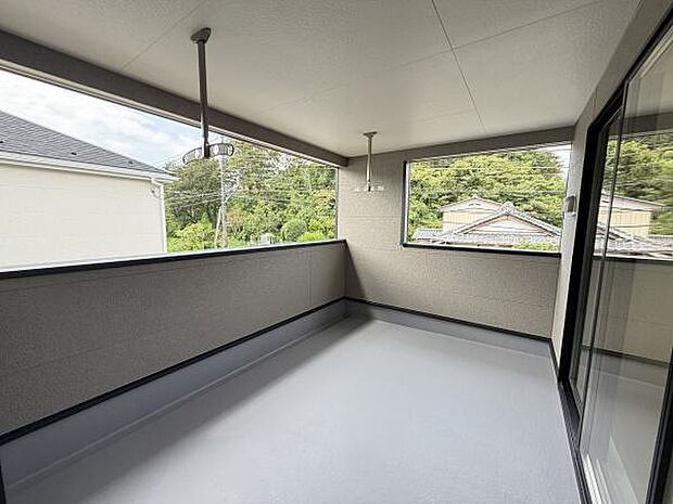 開放感のあるバルコニーで広々とした空間が印象的です。屋根付きのため天候に左右されにくく窓からの眺めも楽しめます。物干し金具付きで毎日の生活にも便利です。清潔感のある仕上がりとなっています。