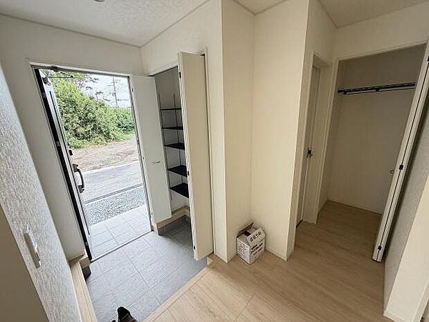 玄関にはシューズボックスが設置されており収納スペースが充実しています。広々とした玄関スペースが印象的です。床はタイルとフローリングが使い分けられており使いやすさが感じられます。