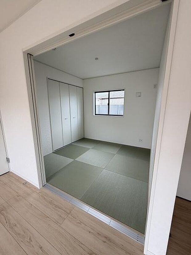 和室はシンプルな内装でゆとりある空間が広がっています。明るい窓から光が入り心地よい雰囲気です。収納スペースも設けられており使い勝手が良いです。引き戸で開閉しやすい設計になっています。