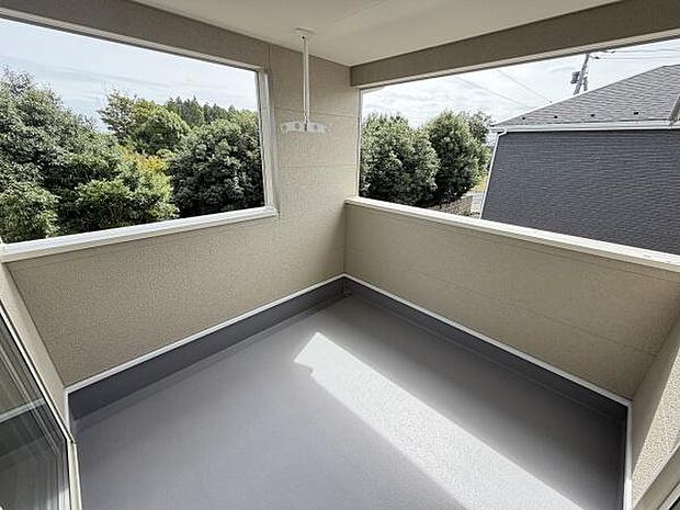 バルコニーはゆとりある空間で窓からの景色が広がります。屋根付きのため天候を気にせず利用できます。室内から出やすい設計で使い勝手も考慮されています。周囲の緑も眺められプライバシーにも配慮された設計です。