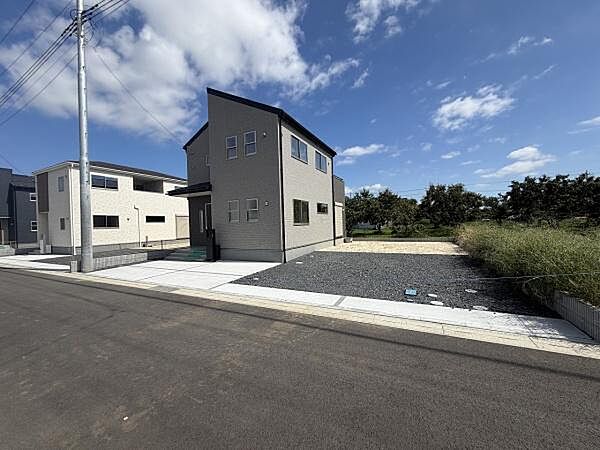広々としたスペースの駐車場が設けられており車の出し入れがしやすい配置です。前面道路もゆったりとしています。住宅に隣接していて利便性があります。周辺には草木があり開放感も感じられます。