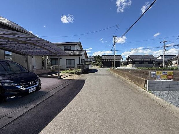 現地は前面道路が広く車の出入りがしやすい環境です。周囲には住宅が立ち並び落ち着いた雰囲気が感じられます。前面道路は舗装されておりアクセスも便利です。空が広く見える開放感もポイントです。