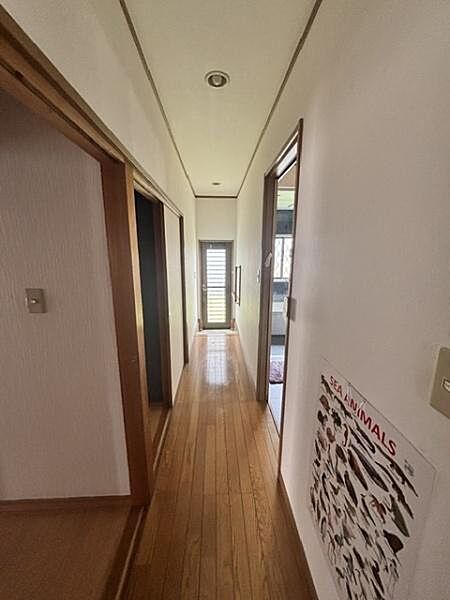 落ち着いた雰囲気の廊下はシンプルで明るい空間が広がっています。床の木目が温かみを感じさせています。直線的なデザインがすっきりとした印象を与えます。