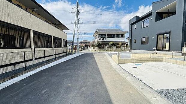 前面道路は幅が広く車の出し入れがしやすい印象です。現地周辺は開放感があり明るい雰囲気です。新しい舗装が特徴的で歩道やフェンスもしっかりしています。周囲の住宅も整然としています。
