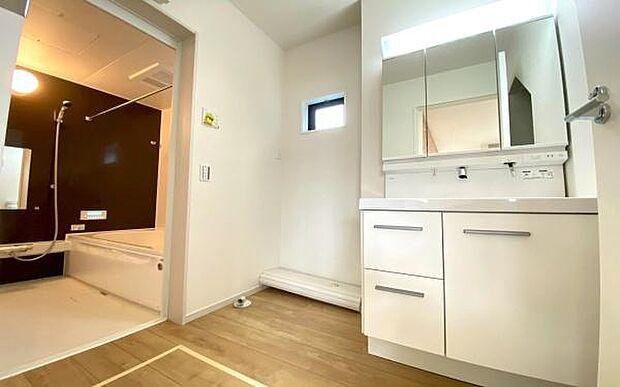 《洗面化粧台》 ■洗面化粧台の鏡は、メイクや髭剃りに便利な三面鏡タイプ。開いて合わせ鏡としても使用できます。鏡の裏側は収納スペースとして利用でき、小物などの保管に便利な棚も付いています。