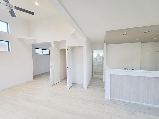 明るい色調の床材が空間全体をすっきりとした印象にしています。天井まで伸びる窓からしっかり自然光が入ります。シンプルな内装が様々なインテリアと調和しやすいリビングです。開放感のある天井設計が特長です。