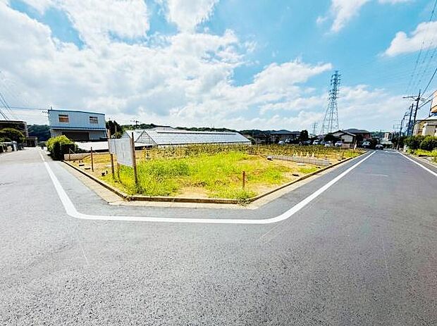角地に位置する現地写真です。道路幅もゆとりがある印象ですっきりとした街並みです。前面道路がしっかりと舗装されており安心感があります。