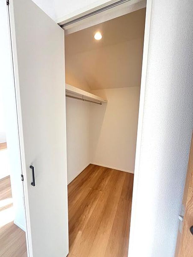 クローゼット内はシンプルな設計で使い勝手が考慮されています。広めの空間が確保されており収納力に余裕があります。上部にはハンガーパイプが備わっており衣類の整理にも便利です。
