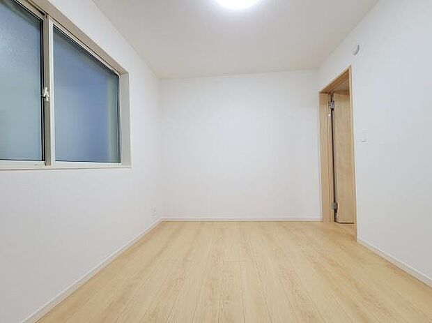 シンプルな内装で様々なインテリアに調和しやすい洋室です。白い壁と明るいフローリングが開放感を演出しています。窓からの自然光が室内をやわらかく包みます。出入りしやすいドアも設けられています。