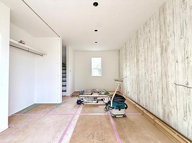 明るい光が差し込む室内に木目調のアクセントクロスが印象的な空間です。シンプルで無駄のないデザインが広がりを感じさせます。収納スペースも設けられており使い勝手が良さそうです。