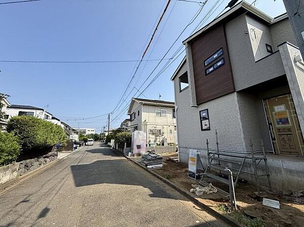 前面道路が広く車の出入りもスムーズに行えます。周囲には緑が多く落ち着いた住宅街です。新築戸建の外観が印象的できれいな街並みが広がっています。青空が広がる開放的な雰囲気のエリアです。