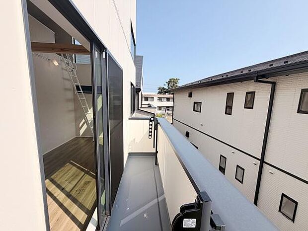 バルコニーは開放感のある空間が広がり日差しがしっかりと入ります。隣接する建物との距離も確保されています。室内とのつながりが感じられるデザインです。ガラス戸は明るさを演出します。