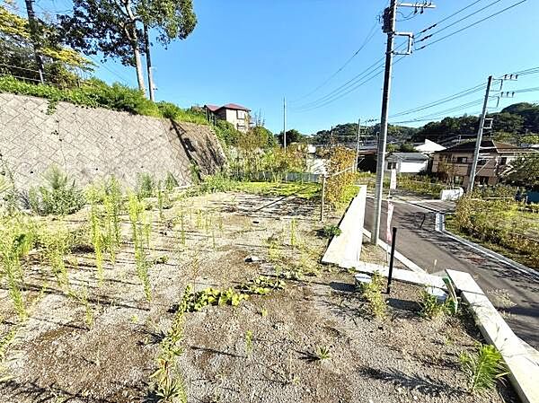 開放感のある現地土地写真です。日当たりが良く道路にも面しておりアクセスもしやすい環境です。周囲に建物が少なく見晴らしも確保されています。住宅街の一角で静かな雰囲気が感じられます。