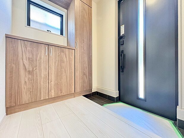 窓から外の光を通す、明るく広い玄関。