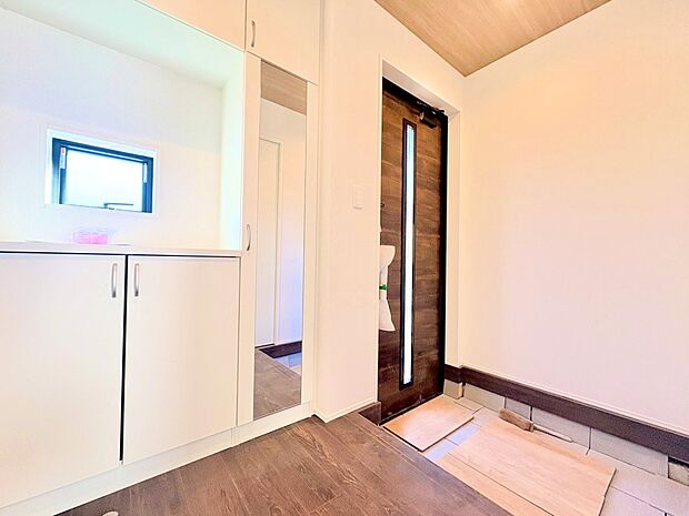 窓から外の光を通す、明るく広い玄関。