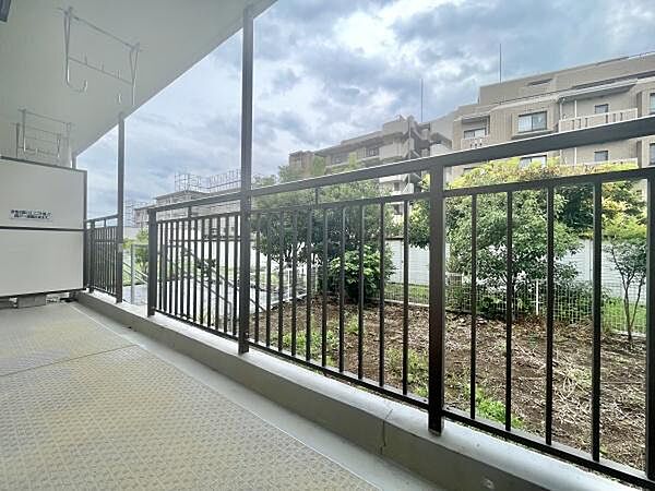 開放感のあるバルコニーからは周囲の緑や建物を見渡すことができます。広々とした空間が確保されておりゆとりを感じられます。手すりも設置されており安全面にも配慮されています。