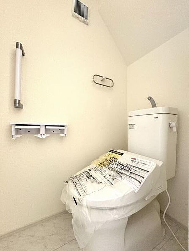 立ち上がりに便利な手すり付きのトイレ。温水洗浄便座です。
