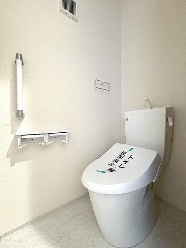 立ち上がりに便利な手すり付きのトイレ。温水洗浄便座です。