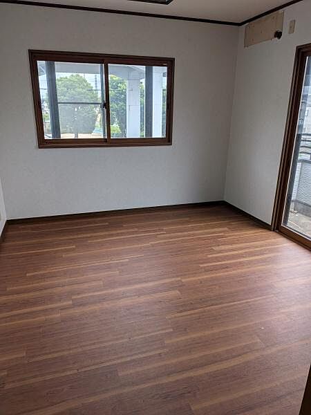 2面の窓から自然光を取り込める洋室。木目の床とシンプルな内装で、お好みの家具を合わせやすい空間です。寝室や子ども部屋、趣味のお部屋など、暮らしに合わせて活用でき、バルコニーにも出入りできます。