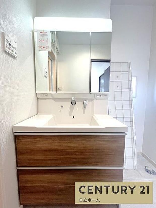 《洗面化粧台》 ■洗面化粧台の鏡は、メイクや髭剃りに便利な三面鏡タイプ。開いて合わせ鏡としても使用できます。鏡の裏側は収納スペースとして利用でき、小物などの保管に便利な棚も付いています。