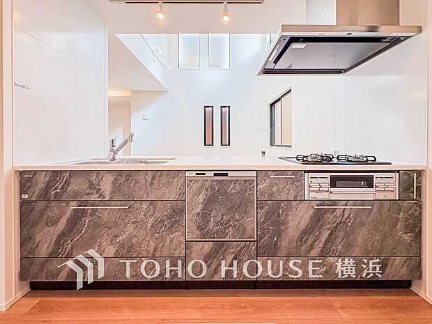 機能性とデザイン性を兼ね備えたシステムキッチン。リビングとの一体感も考慮され、美しい空間が実現。