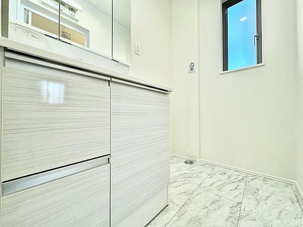 三面鏡付き洗面化粧台。合わせ鏡で後ろのスタイリングも快適。鏡の後ろは収納になっているので、細々したものを収納でき、スッキリとした洗面回りに。