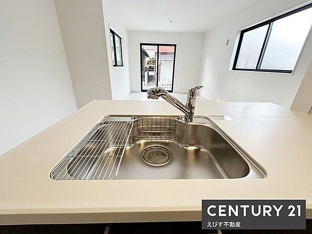 ステンレスシンクが印象的なキッチンです。作業スペースが広く使いやすいです。窓からの光が明るい空間を演出します。全体的にシンプルで清潔感があります。毎日の作業が快適に進みます。