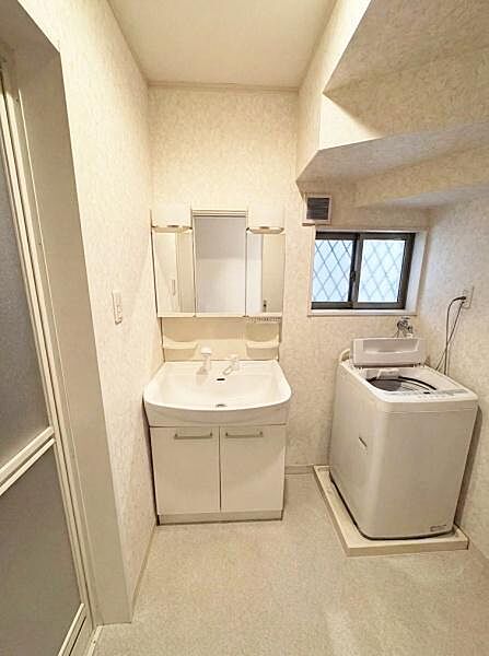 【一部AIモノ消し済み・実際の室内状況優先】洗面台と洗濯機の配置が効率的で空間を広く活用できます。窓があるため採光や換気に役立ちます。清潔感のあるデザインが日々の暮らしをサポートします。