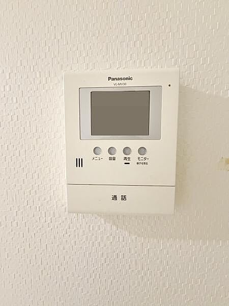 シンプルなデザインのモニター付きインターホンが設置されています。画面とボタンが分かりやすく配置されており操作がしやすい仕様です。壁面の質感とも調和しておりお部屋の雰囲気を損ないません。